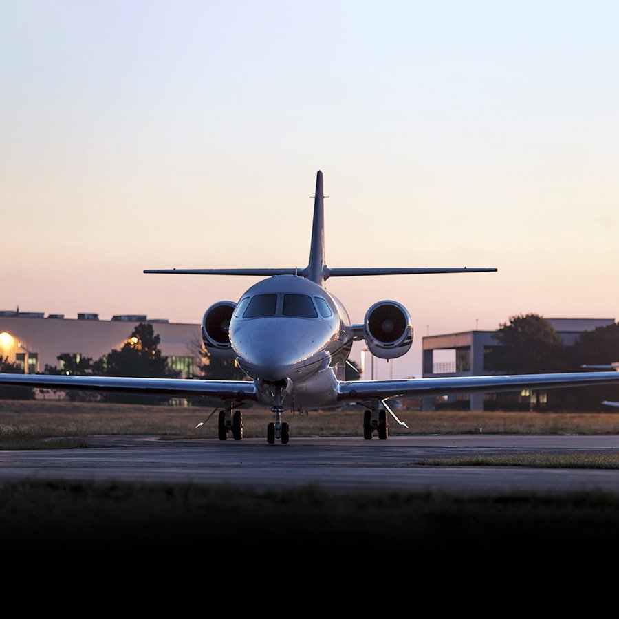A private jet on the tarmac at dusk