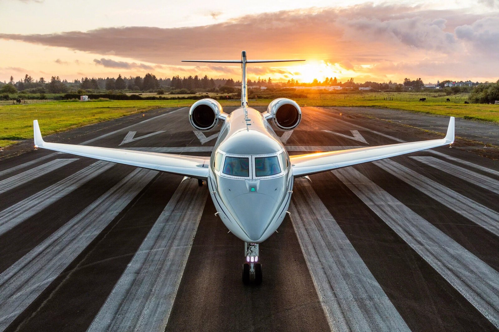 Private jet on a runway at sunset
